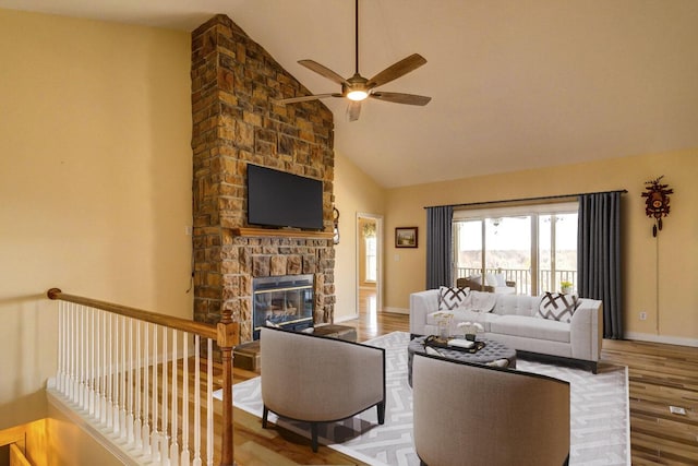 1794 Hunter Dr, Lancaster, KY 40444 - living room featuring wood finished floors, ceiling fan, high vaulted ceiling, baseboards, and a stone fireplace