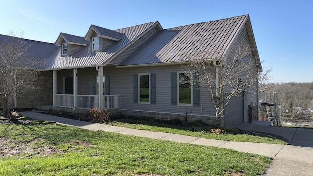 1794 Hunter Dr, Lancaster, KY 40444 - view of front facade featuring covered porch, metal roof, a front yard, and a garage
