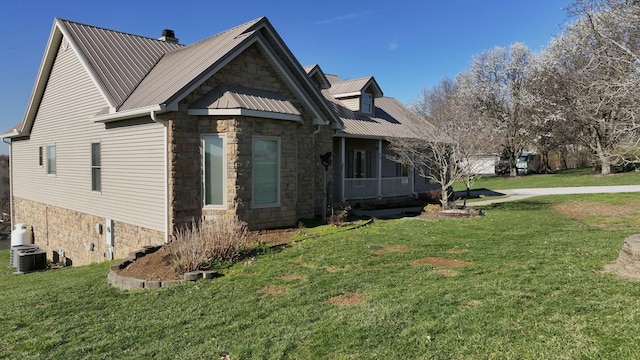 1794 Hunter Dr, Lancaster, KY 40444 - view of side of home with stone siding, a lawn, cooling unit, and covered porch