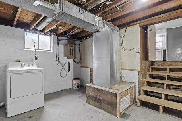basement featuring electric panel and washer / dryer