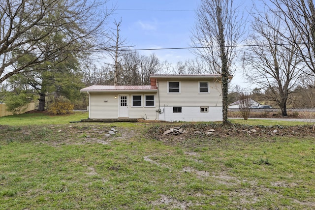 view of front of home featuring a front lawn and metal roof