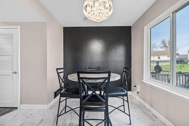 101 Bell Lawn Dr, Nicholasville, KY 40356 - dining area featuring baseboards, an accent wall, marble finish floor, visible vents, and a notable chandelier