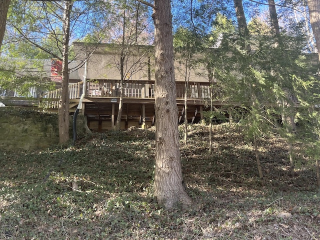 back of property with a wooden deck