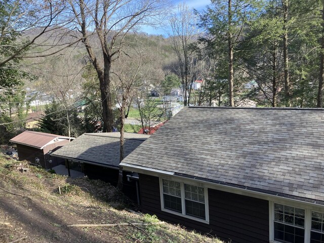 view of side of home featuring a shingled roof