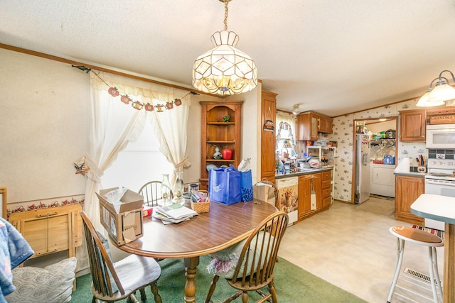 360 N Middletown Rd, Winchester, KY 40391 - dining room featuring a textured ceiling, vaulted ceiling, wallpapered walls, and separate washer and dryer