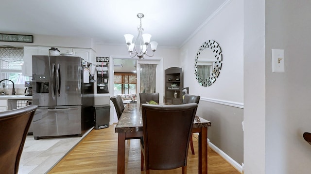 3485 Twillingate Ct, Lexington, KY 40503 - dining space with a chandelier, crown molding, and light wood finished floors