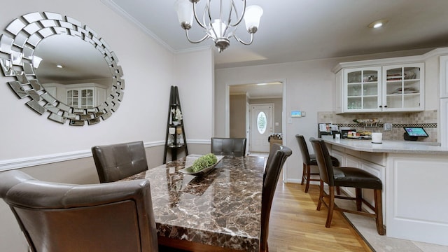 3485 Twillingate Ct, Lexington, KY 40503 - dining space with light wood-style floors, a chandelier, crown molding, and recessed lighting