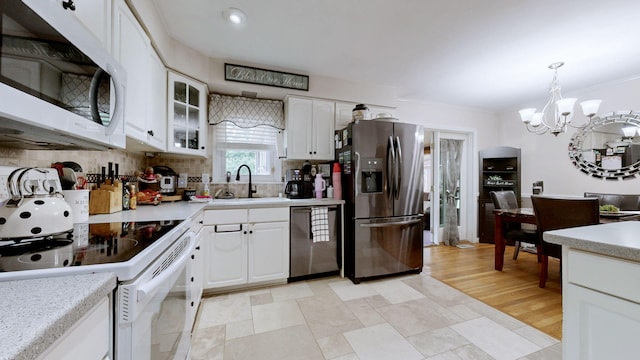 3485 Twillingate Ct, Lexington, KY 40503 - kitchen featuring stainless steel appliances, a chandelier, light countertops, tasteful backsplash, and ornamental molding