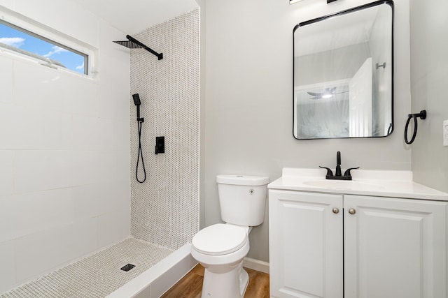 104 W 1st St, Silver Grove, KY 41085 - bathroom with a tile shower, wood finished floors, toilet, and vanity