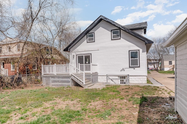 104 W 1st St, Silver Grove, KY 41085 - back of property featuring a lawn, a wooden deck, and fence