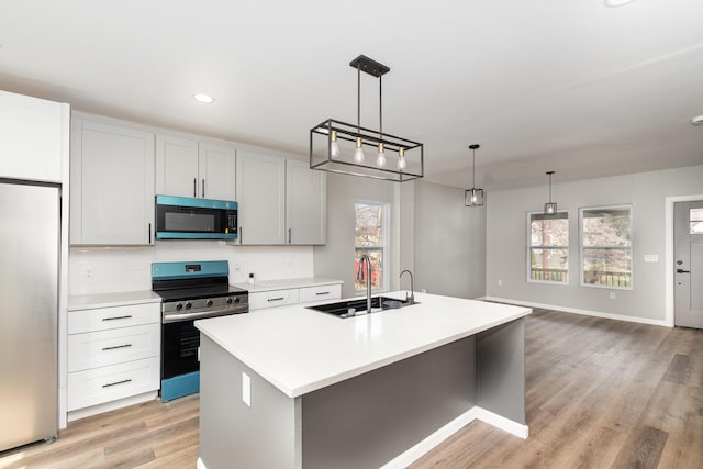 104 W 1st St, Silver Grove, KY 41085 - kitchen featuring light countertops, a sink, stainless steel appliances, a kitchen island with sink, and decorative backsplash