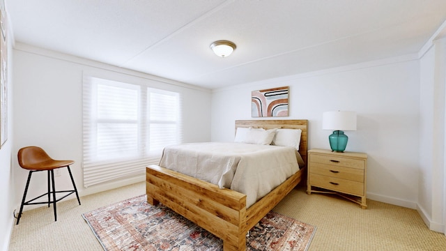 bedroom featuring baseboards and light carpet