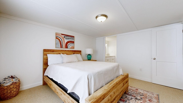 bedroom featuring baseboards, carpet floors, and ensuite bathroom
