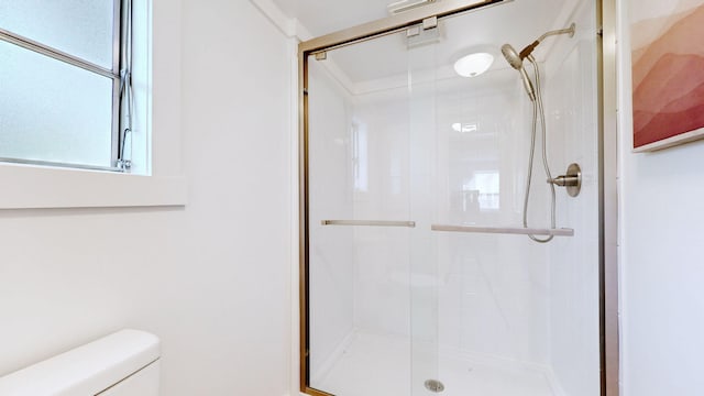 full bath with a shower stall and toilet