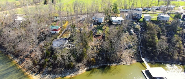 aerial view featuring a wooded view and a water view
