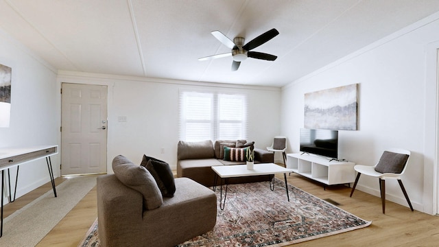 living area featuring baseboards, light wood-style floors, and ceiling fan