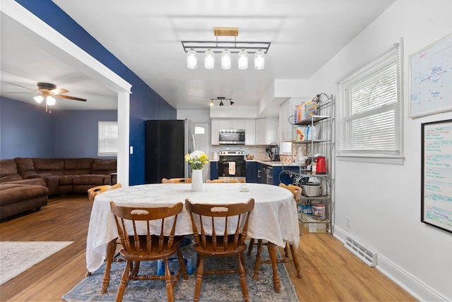 dining area with visible vents, plenty of natural light, and light wood-style floors
