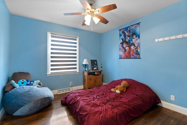 bedroom with a baseboard radiator, ceiling fan, wood finished floors, and baseboards