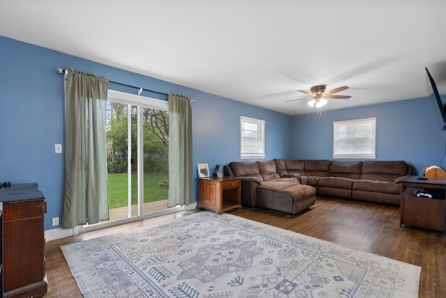 living room with a ceiling fan and wood finished floors