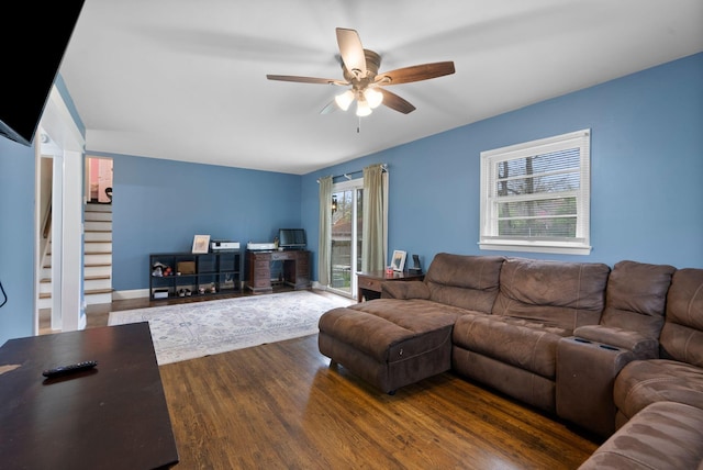 living room with wood finished floors and ceiling fan