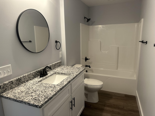 full bathroom with vanity, toilet, wood finished floors, and  shower combination