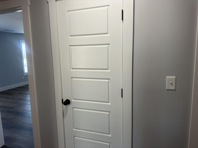 room details featuring baseboards and wood finished floors