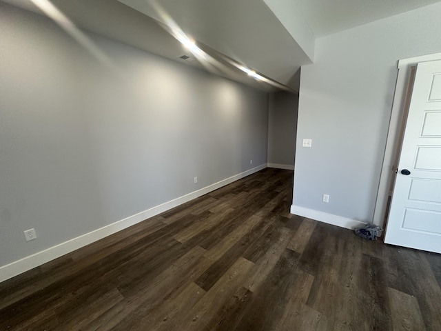 interior space with baseboards and dark wood-style flooring