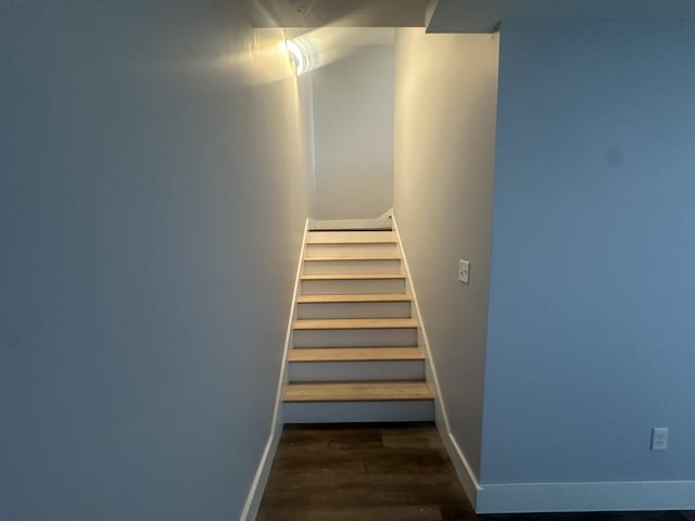 stairway with baseboards and wood finished floors