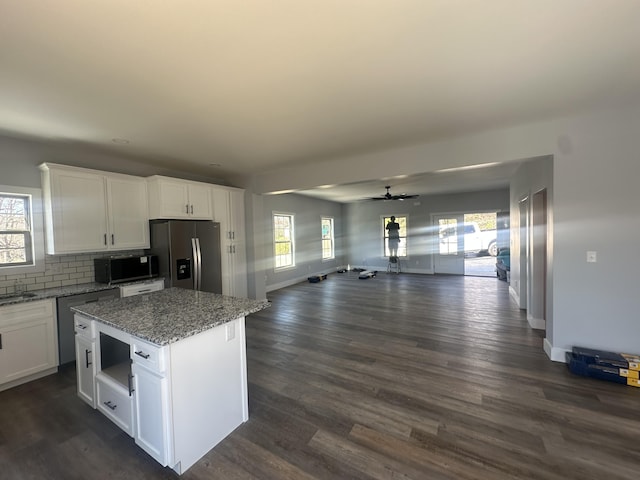 kitchen featuring stainless steel fridge with ice dispenser, ceiling fan, dark wood-style floors, and open floor plan