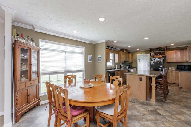 dining room with crown molding, baseboards, a textured ceiling, and recessed lighting