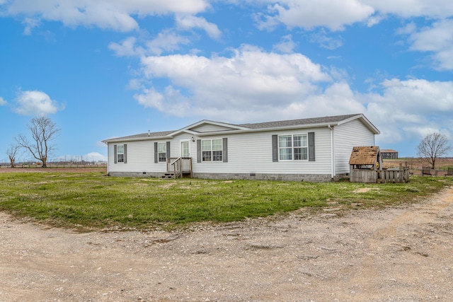 manufactured / mobile home featuring a shingled roof, crawl space, and a front yard