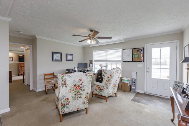 living area featuring a ceiling fan, carpet floors, ornamental molding, and a healthy amount of sunlight