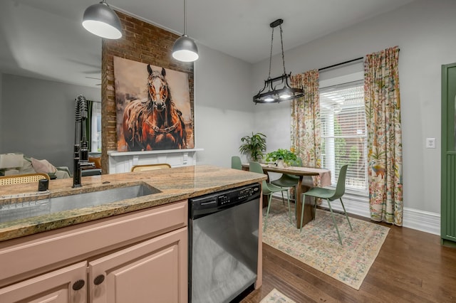 kitchen featuring dishwasher, a sink, dark wood-type flooring, pendant lighting, and light stone counters