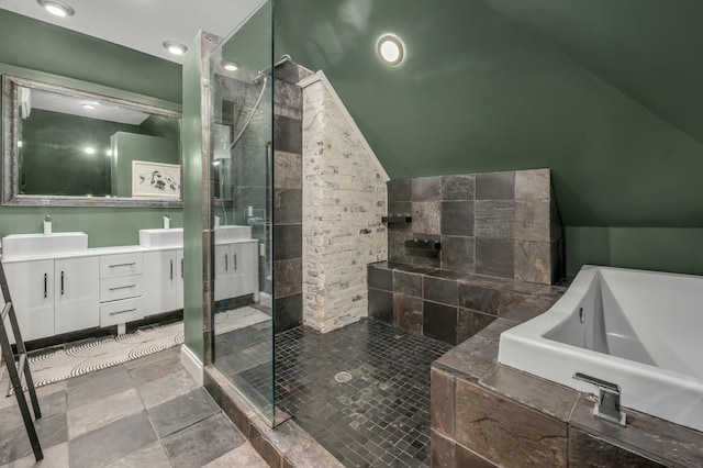 full bath with a shower stall, vanity, a tub to relax in, and vaulted ceiling