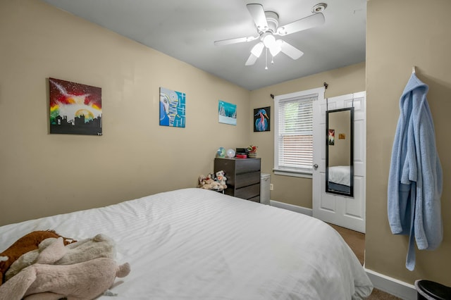carpeted bedroom featuring ceiling fan and baseboards
