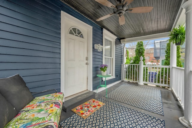 doorway to property with covered porch and a ceiling fan