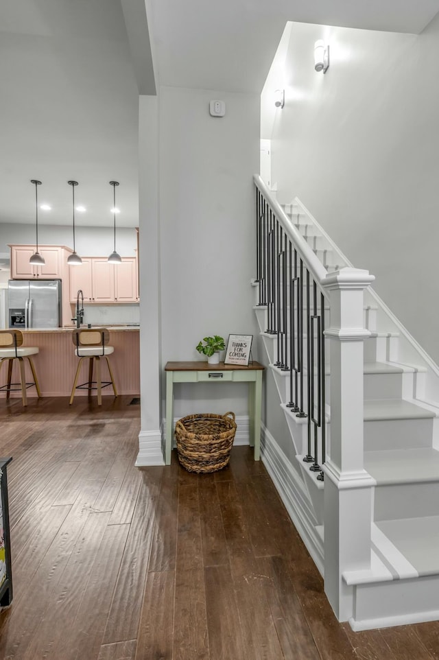 stairs featuring recessed lighting, baseboards, and hardwood / wood-style flooring