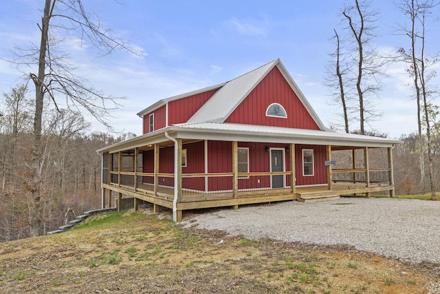 view of front of home with metal roof, a porch, and board and batten siding