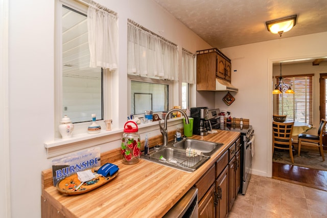 kitchen featuring a sink, a wealth of natural light, stainless steel electric range oven, and wood counters