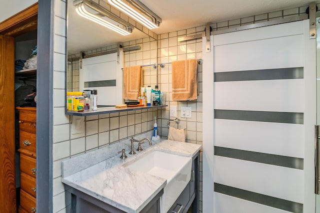 bathroom featuring vanity, tile walls, and decorative backsplash