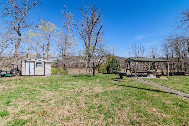 view of yard featuring an outbuilding, a gazebo, and a storage unit