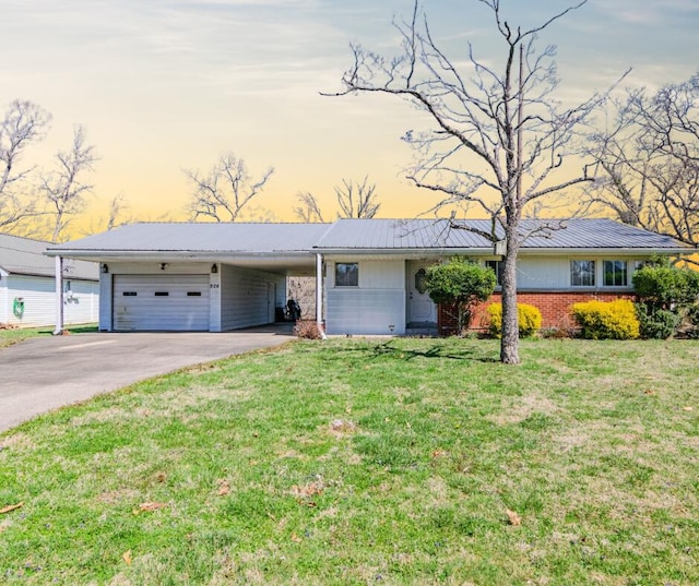 single story home featuring a front yard, driveway, metal roof, and a carport
