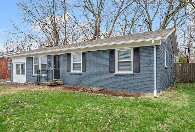 single story home with brick siding, fence, and a front yard
