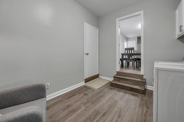 sitting room with baseboards, light wood-style floors, and washer / dryer