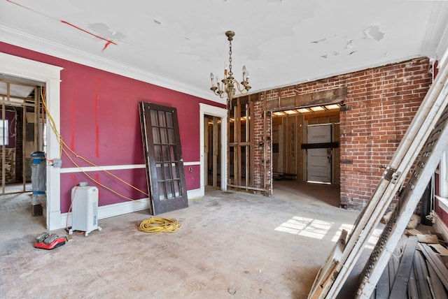 236 Clay Ave, Lexington, KY 40502 - unfurnished dining area featuring baseboards, brick wall, ornamental molding, and an inviting chandelier