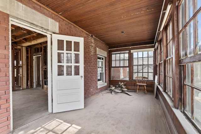 236 Clay Ave, Lexington, KY 40502 - unfurnished sunroom featuring hardwood / wood-style flooring, wooden ceiling, and brick wall
