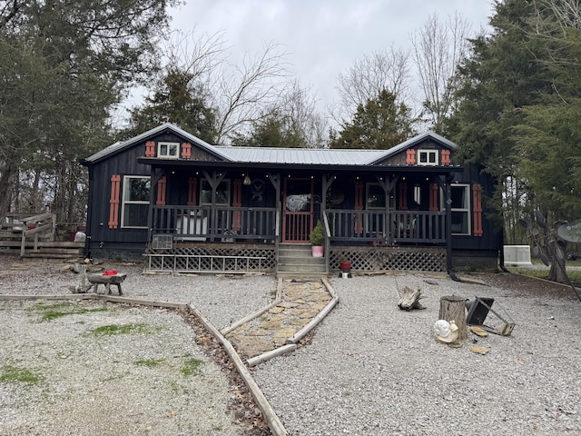 chalet / cabin featuring covered porch and metal roof