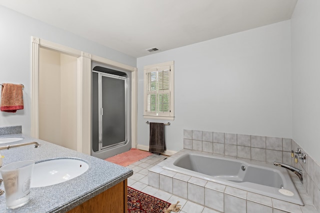 bathroom featuring a shower stall, double vanity, and a bath
