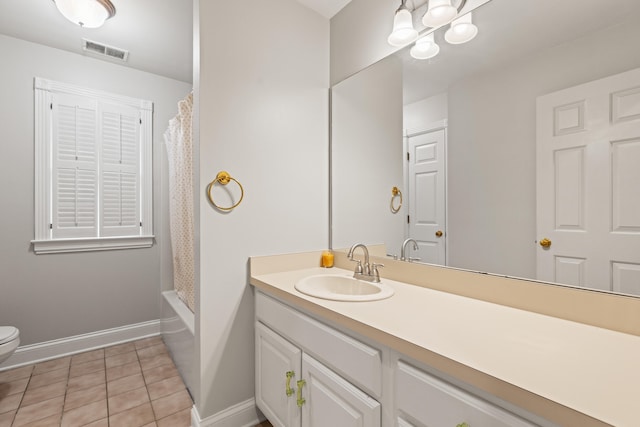 full bath featuring baseboards, vanity, toilet, and tile patterned flooring