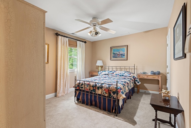 carpeted bedroom featuring baseboards and a ceiling fan